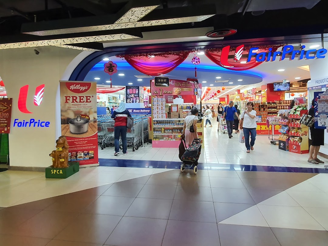 Bustling entrance of FairPrice supermarket with shoppers and promotional displays.