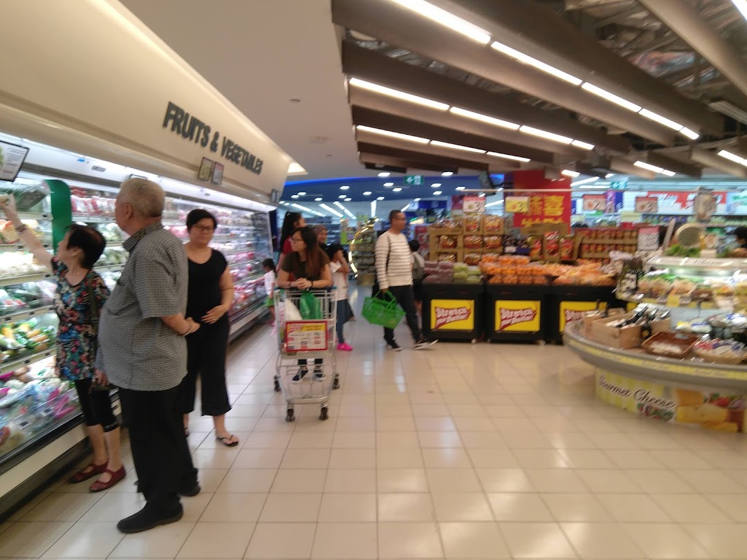 Shoppers browse fresh produce and groceries in the brightly lit FairPrice supermarket.