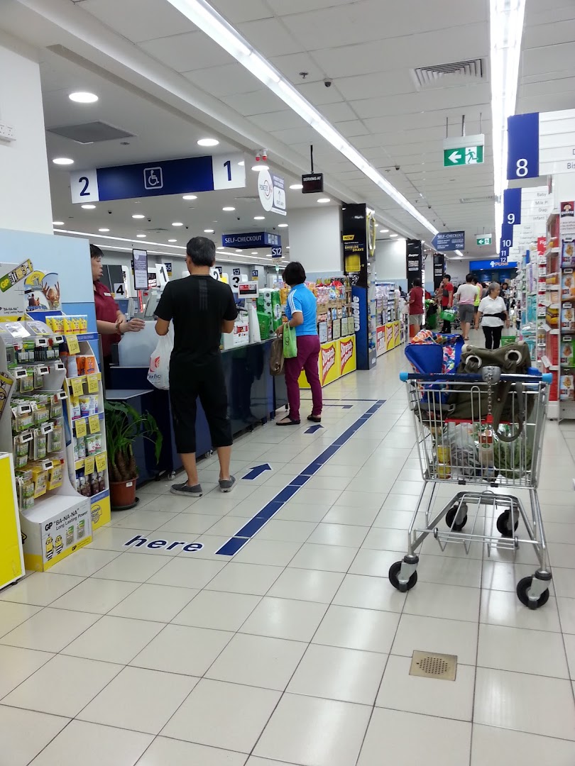 Customers queueing at the self-checkout and regular lanes inside a FairPrice supermarket.