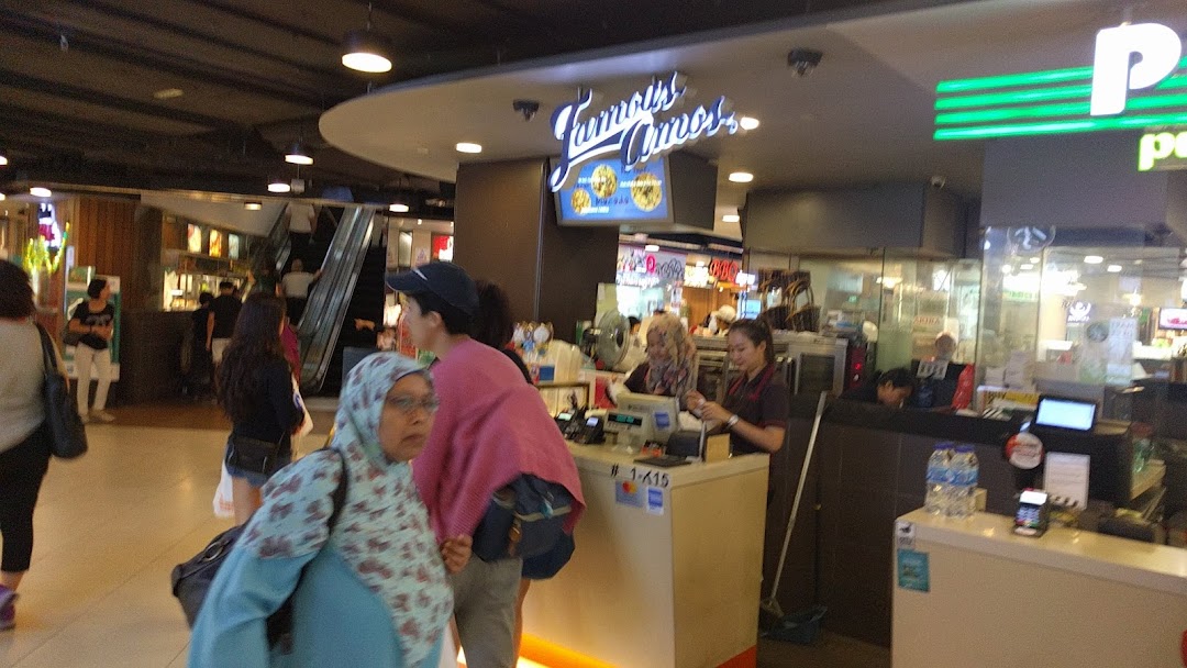 Famous Amos counter with staff serving customers and prominent shop signage.