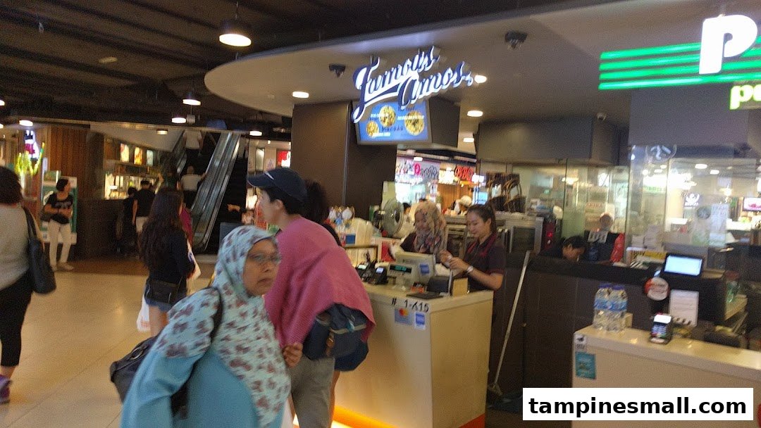 Famous Amos counter with staff serving customers and prominent shop signage.