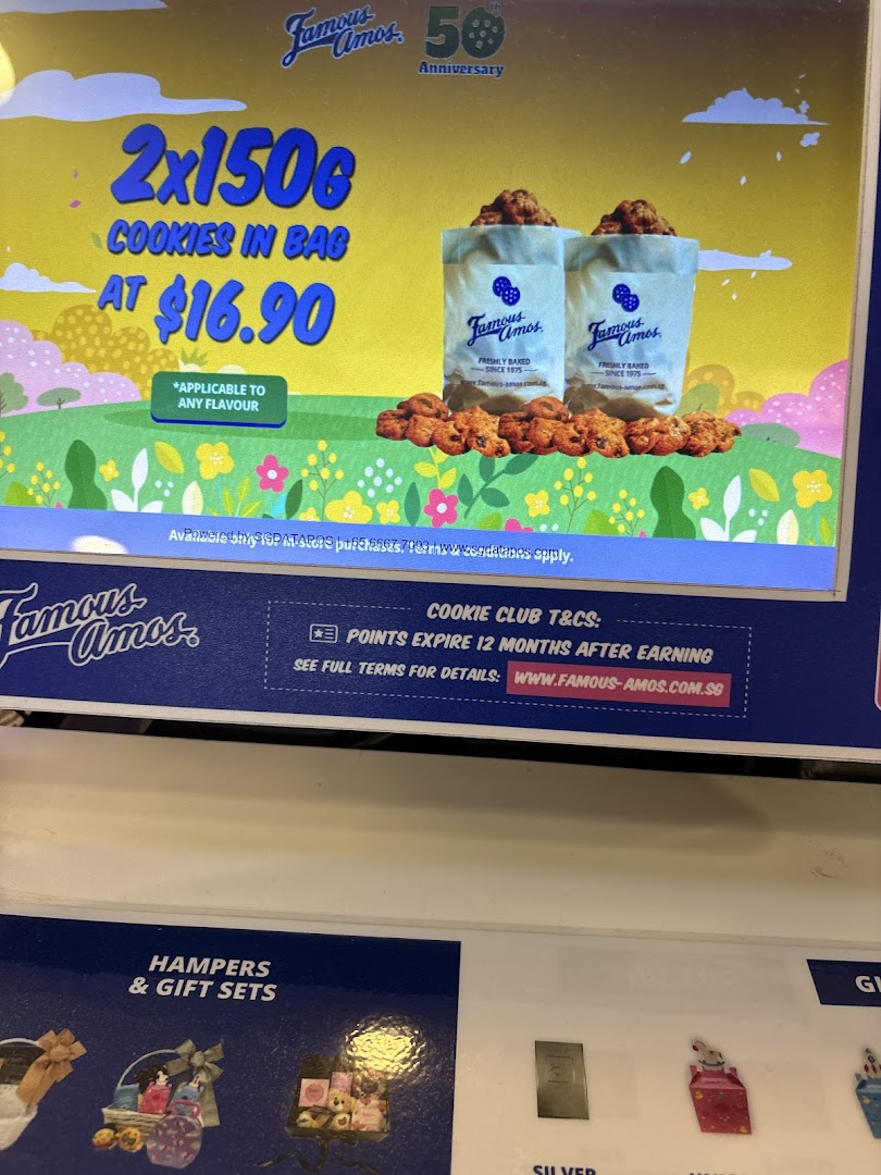 A digital display inside Famous Amos showcasing a cookie promotion and loyalty program details.