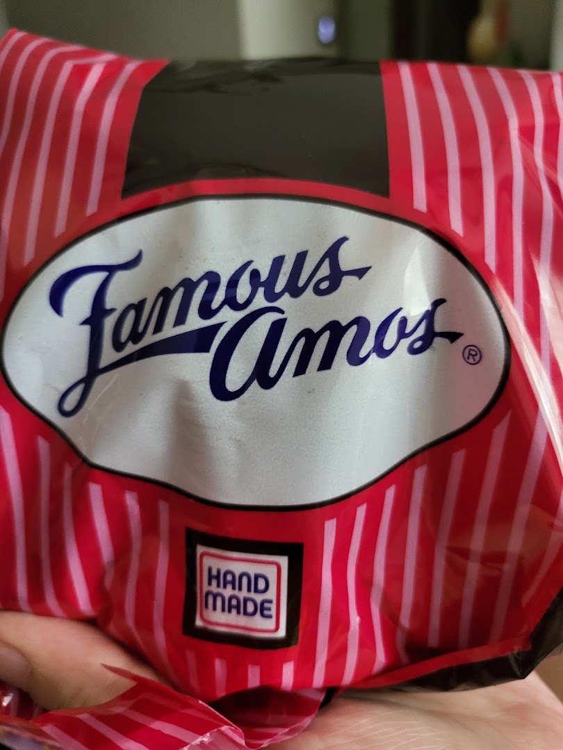 Close-up of a Famous Amos cookie bag featuring the brand logo and 'Hand Made' label.