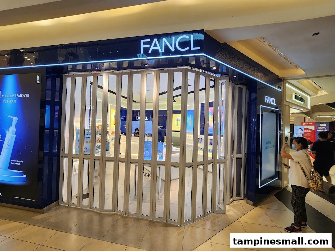 The FANCL shop entrance at Tampines Mall, featuring a large product display and folding glass doors.