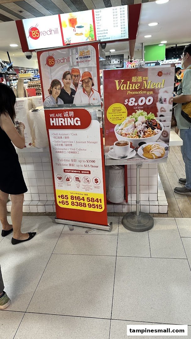 A food stall featuring a drinks menu, a value meal promotion, and a hiring advertisement.