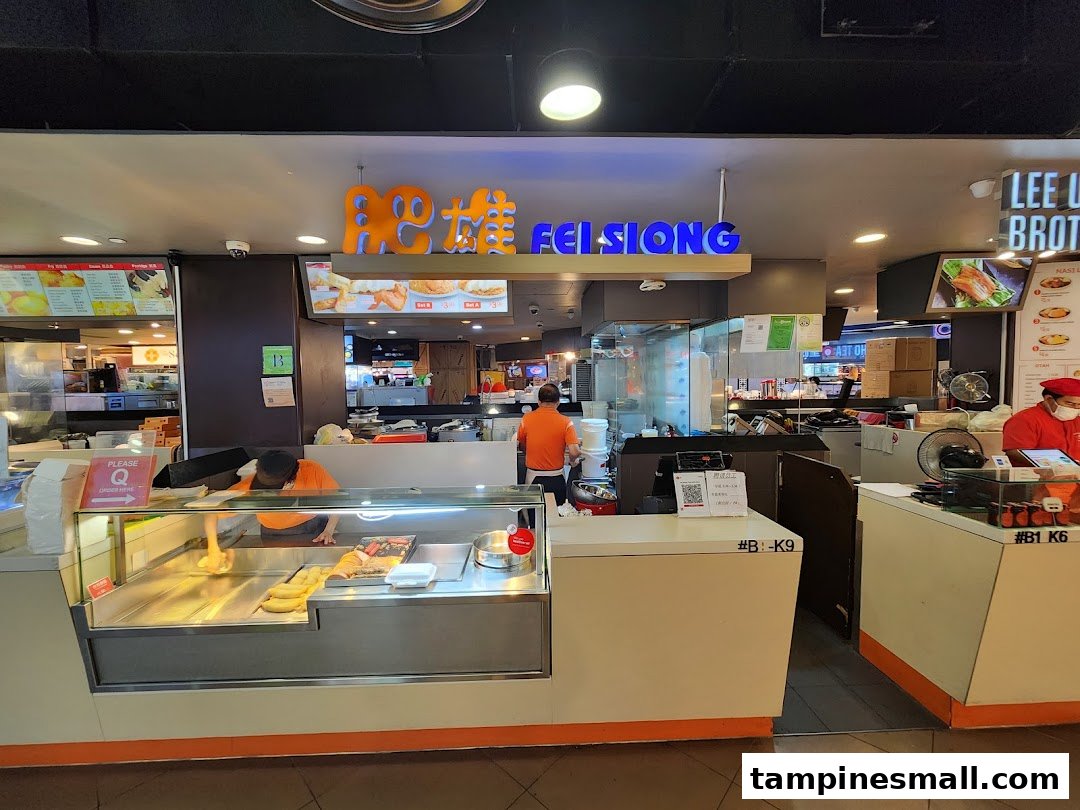 Fei Siong food stall front counter with staff and prominent signage in a bustling mall setting.