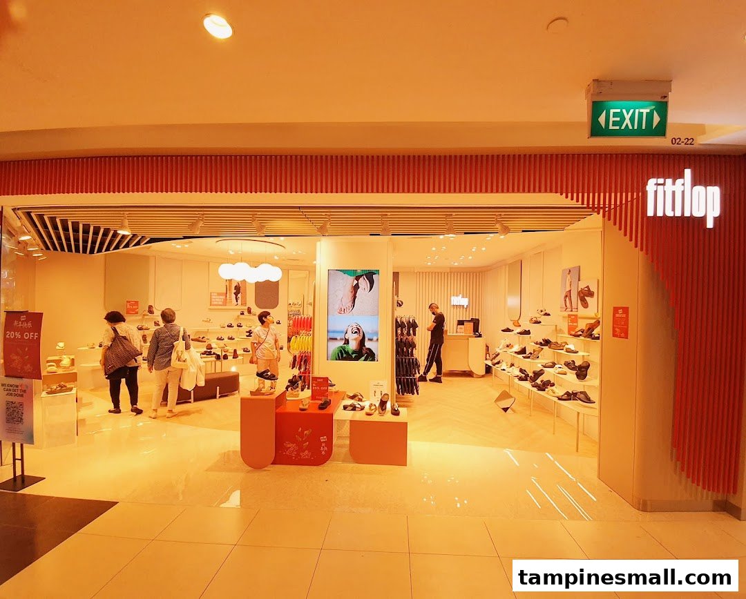 The bright and inviting shop front of FitFlop Tampines, showcasing a wide range of comfortable footwear and active shoppers.