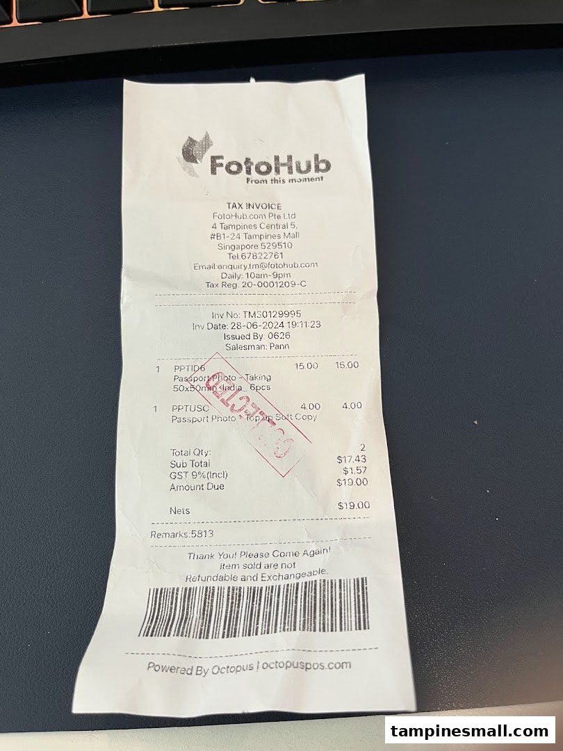 A FotoHub tax invoice detailing passport photo services and charges.