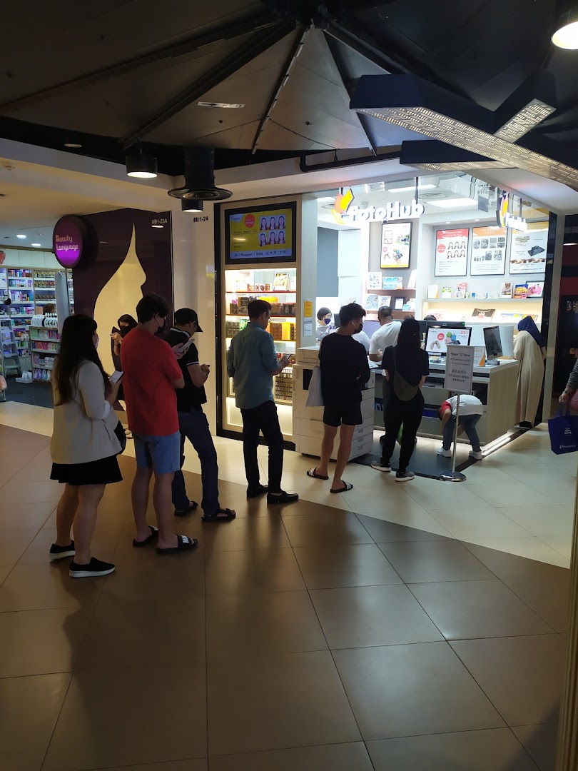 Customers queueing outside FotoHub, a photo printing and imaging services shop in Tampines Mall.