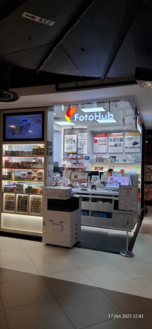 The FotoHub shop front displays its logo, photo printing services, and personalized gift options like FotoMugs.