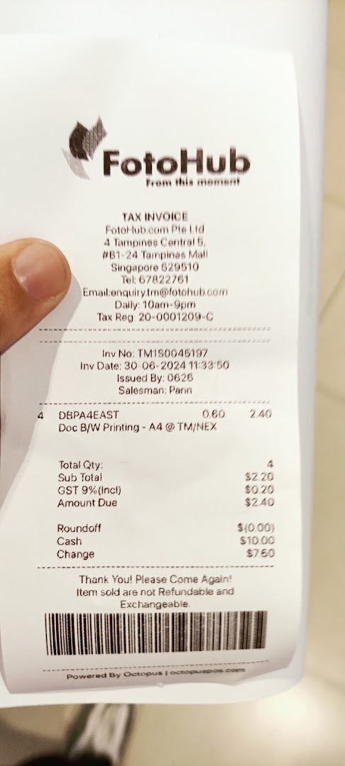 A FotoHub tax invoice showing details for a black and white A4 printing service.