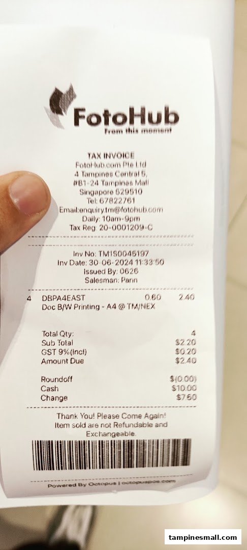 A FotoHub tax invoice showing details for a black and white A4 printing service.