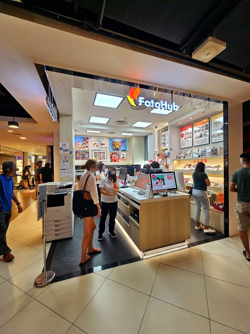 The FotoHub shop front at Tampines Mall, showcasing its services and inviting customers inside.