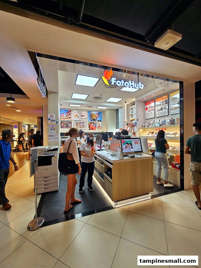 The FotoHub shop front at Tampines Mall, showcasing its services and inviting customers inside.
