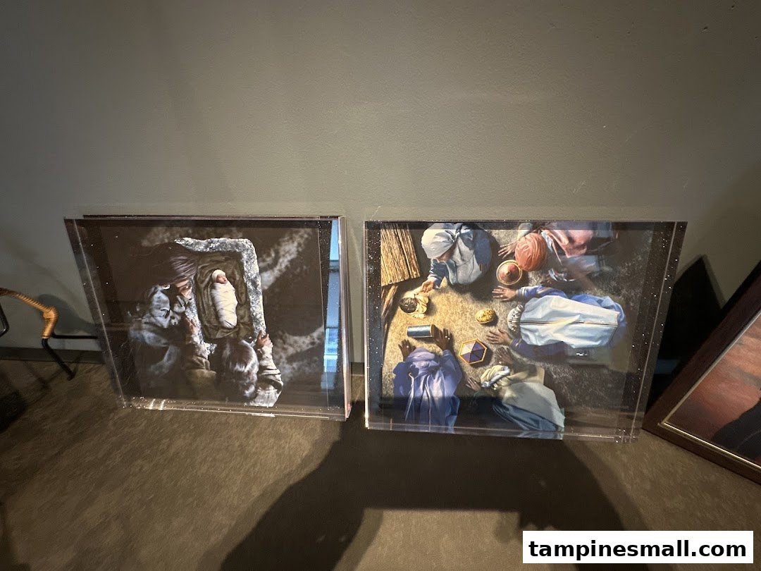 Two framed art prints featuring biblical or historical scenes displayed in a FotoHub store.