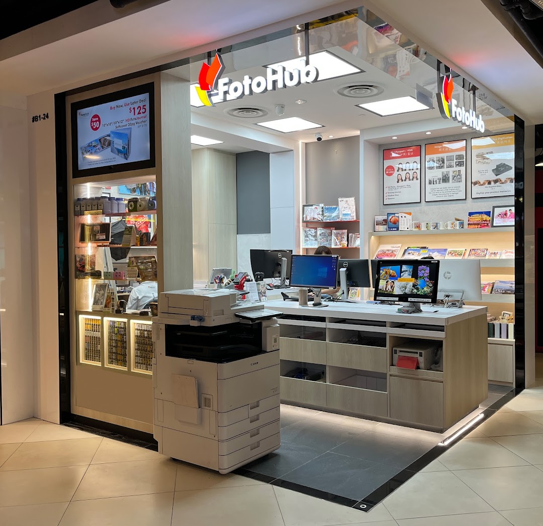 FotoHub shop entrance showcasing photo printing services, digital displays, and various photo products.