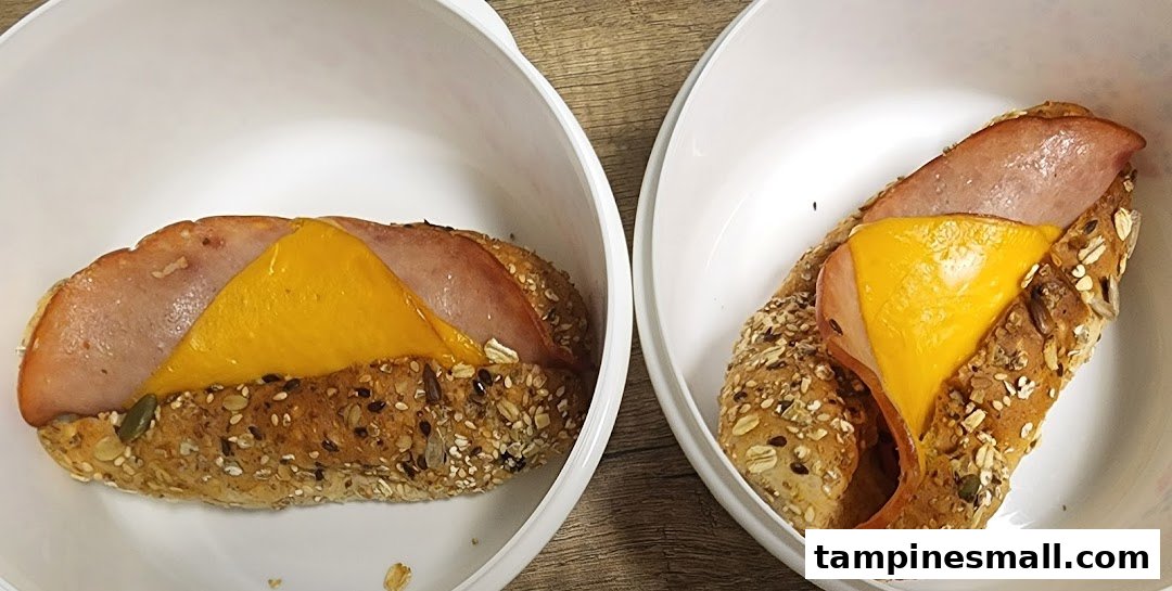 Two delicious ham and cheese sandwiches on seeded bread, presented in white bowls.