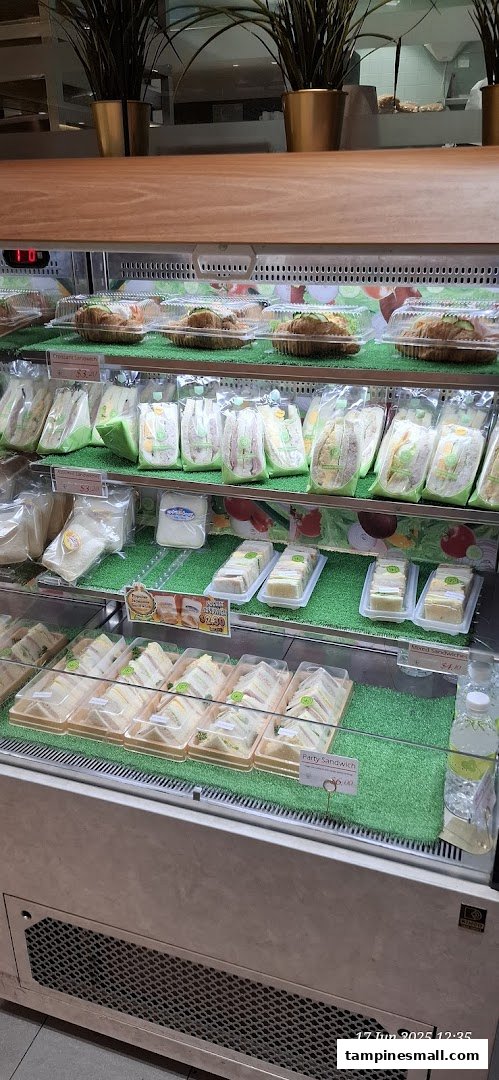 A refrigerated display case showcasing a variety of fresh, pre-packaged sandwiches and croissants.