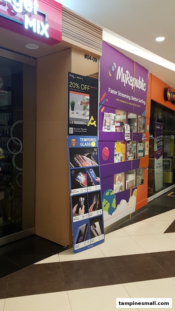 The entrance of Gadget Mix, a tech accessories shop, with promotional displays for tempered glass and a 20% off offer.