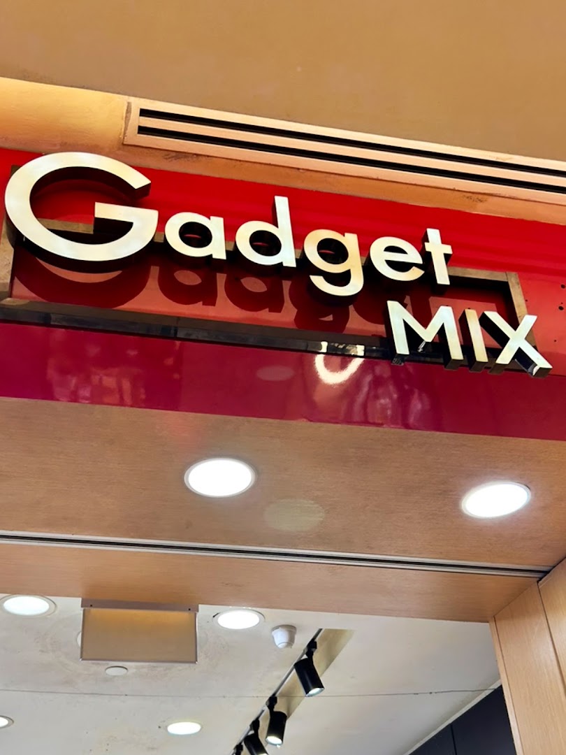 The shopfront sign for 'Gadget Mix' featuring gold lettering on a vibrant red background above the entrance.