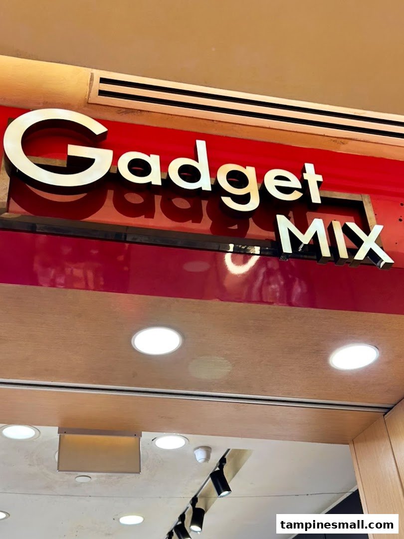 The shopfront sign for 'Gadget Mix' featuring gold lettering on a vibrant red background above the entrance.