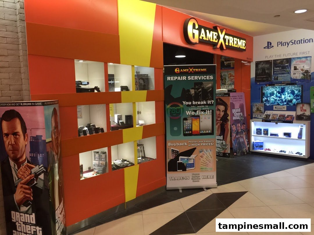 The vibrant orange and yellow GameXtreme shop entrance, featuring gaming displays, repair services, and trade-in offers.