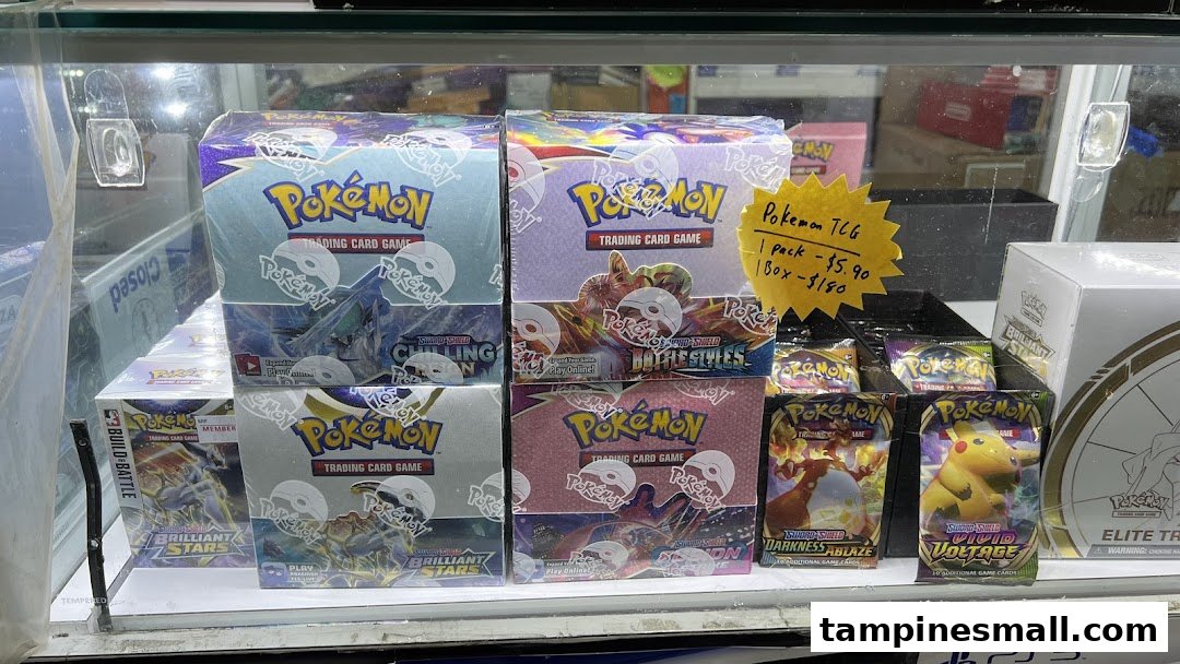 A display case showcasing various Pokémon Trading Card Game booster boxes and packs.