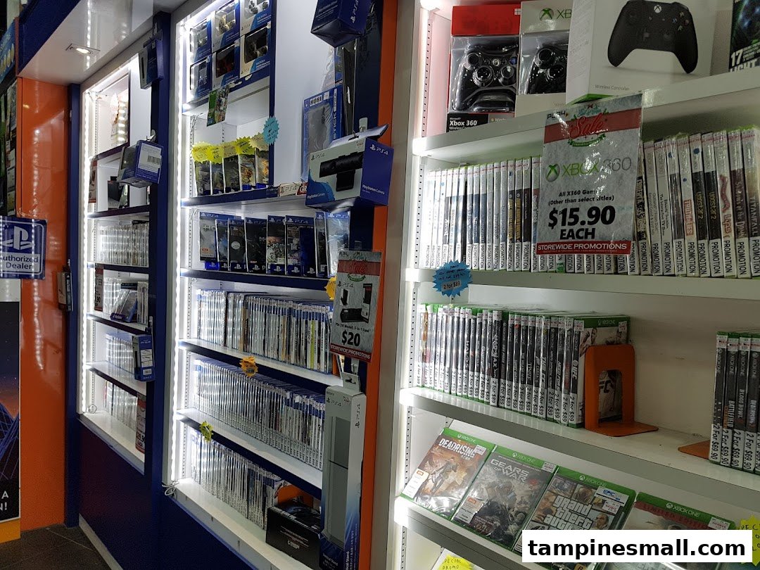 Shelves filled with PlayStation and Xbox video games, controllers, and accessories at GameXtreme Tampines.