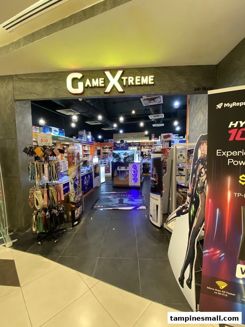 The vibrant entrance of GameXtreme, an electronics and gaming store, showcasing various products and displays.