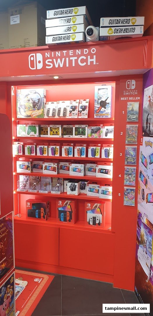 A vibrant red display showcasing Nintendo Switch consoles, controllers, accessories, and best-selling games.