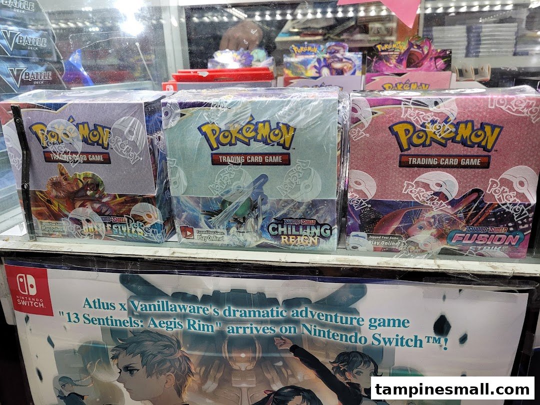 Pokemon Trading Card Game booster boxes and a Nintendo Switch game poster displayed in a retail shop.