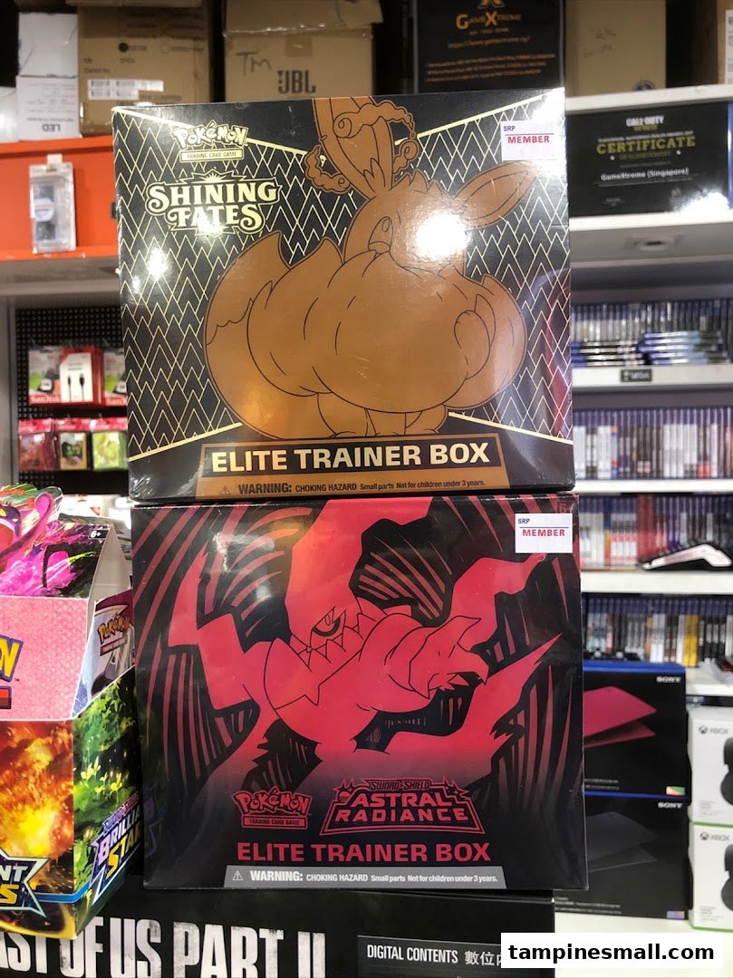 Two Pokemon Trading Card Game Elite Trainer Boxes (Shining Fates and Astral Radiance) displayed in a retail store.