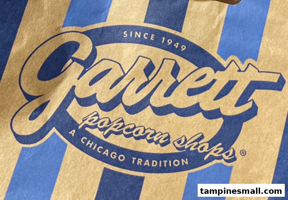 Close-up of the iconic Garrett Popcorn Shops logo on a classic striped bag.