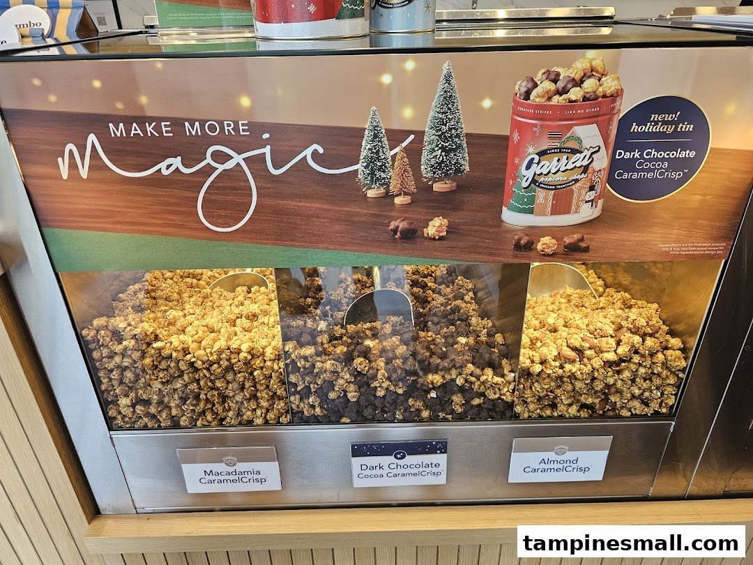 A vibrant display of Garrett Popcorn flavors, including holiday specials, showcased in a retail setting.