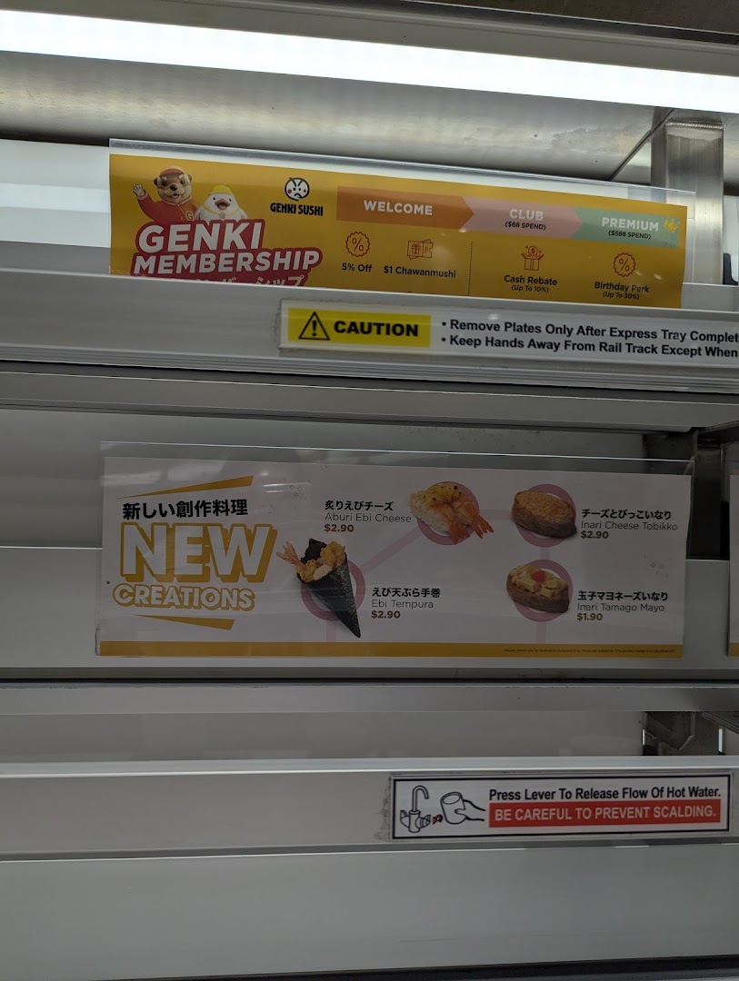 Close-up of Genki Sushi's in-store display featuring new menu creations and membership details.