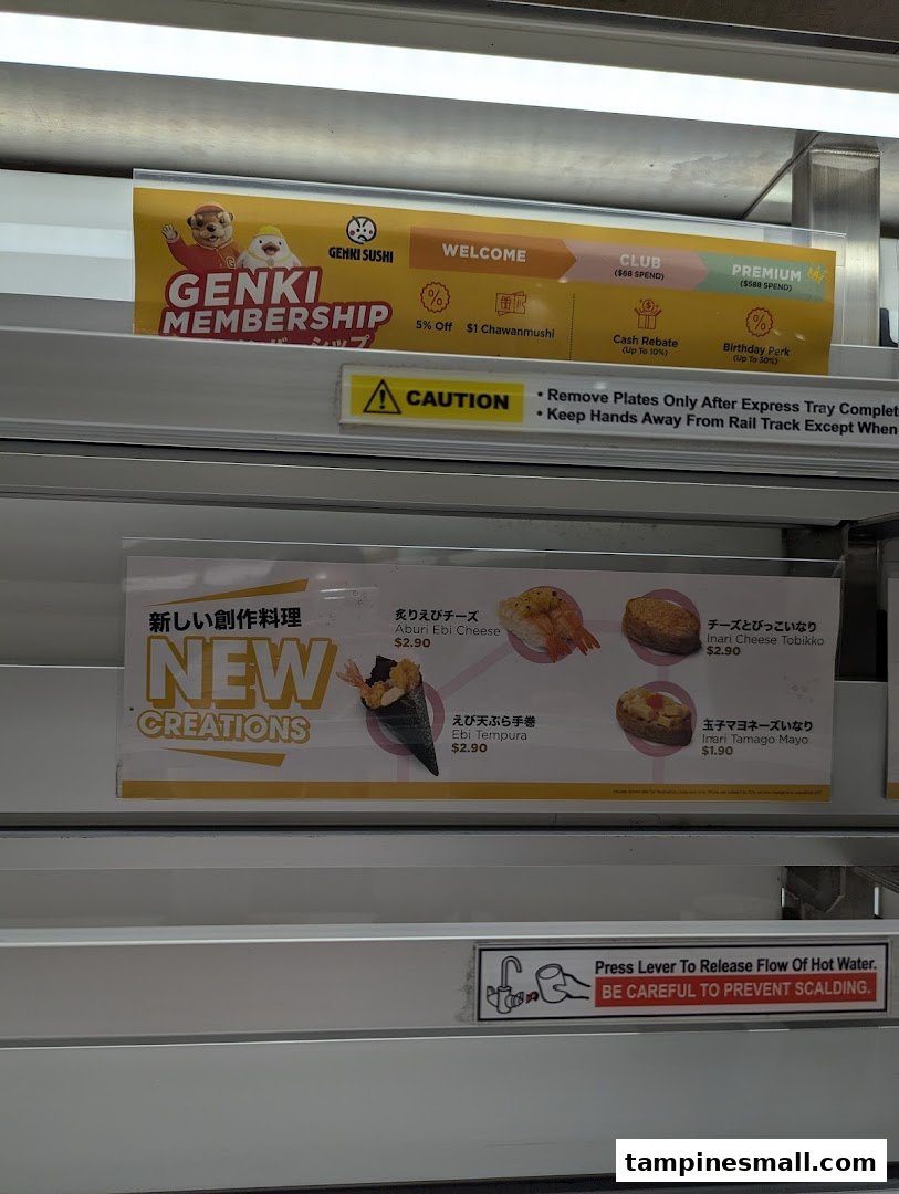 Close-up of Genki Sushi's in-store display featuring new menu creations and membership details.