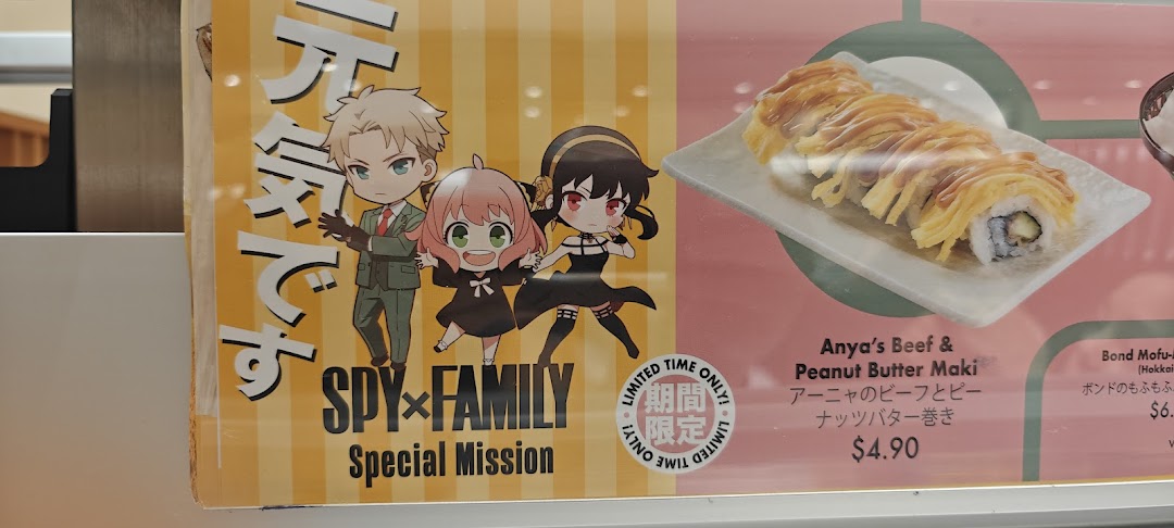 A promotional menu board at Genki Sushi featuring Spy x Family collaboration items and prices.