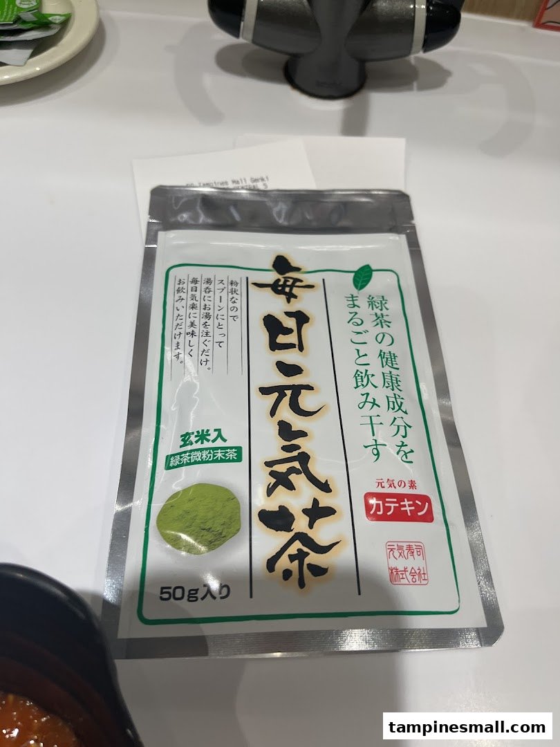A packet of Genki Tea (green tea powder) on a table inside Genki Sushi.