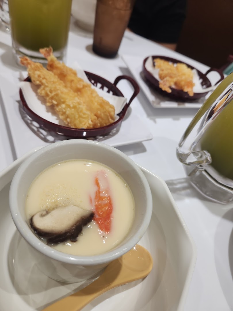 A close-up of chawanmushi and tempura shrimp served on a table at Genki Sushi.