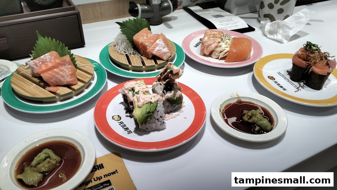 Various fresh sushi and sashimi dishes served on plates at Genki Sushi.