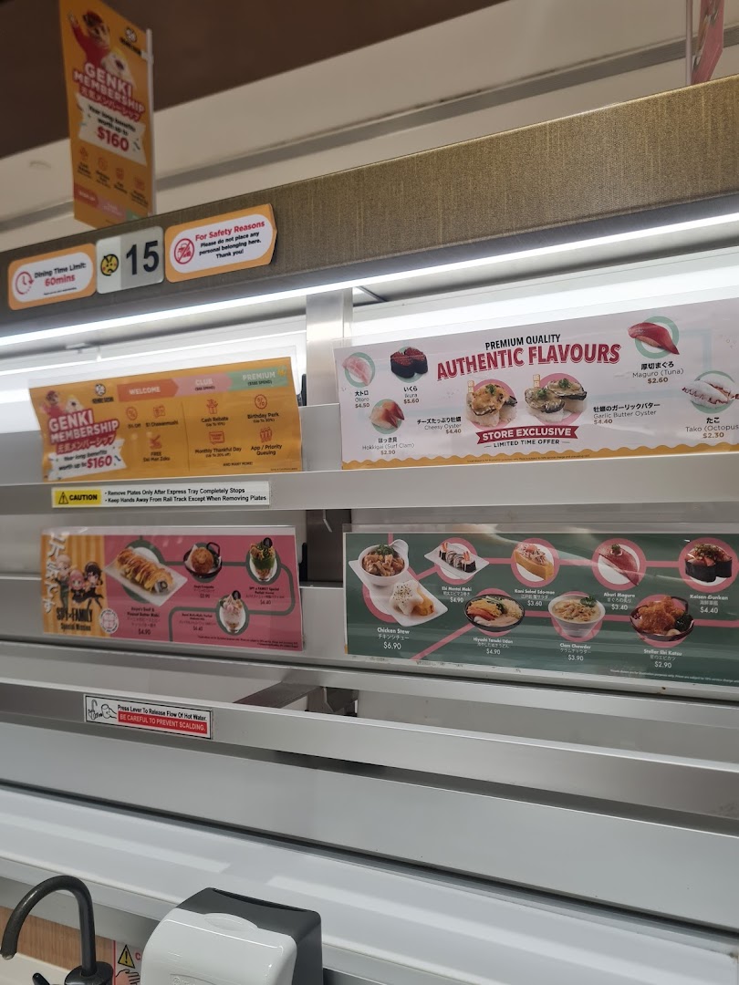 Conveyor belt sushi restaurant interior with various dishes, promotions, and safety signs.