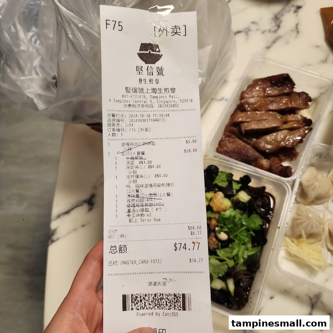 A receipt from 堅信號上海生煎皇 alongside various takeout food containers.