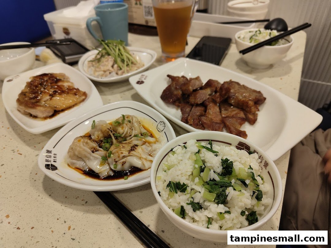 A table laden with delicious Chinese dishes including chicken, pork, dumplings, and rice.