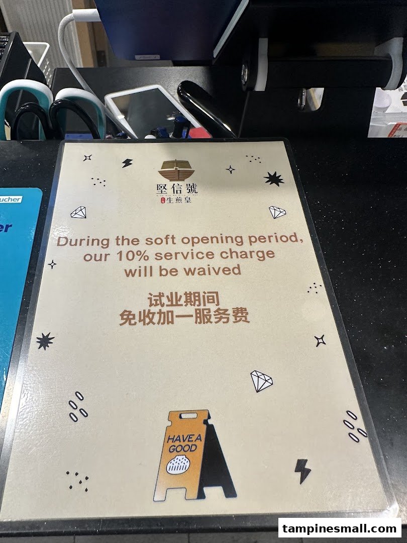 A sign at Ging Sun Ho King of Bun announcing a waived 10% service charge during soft opening.