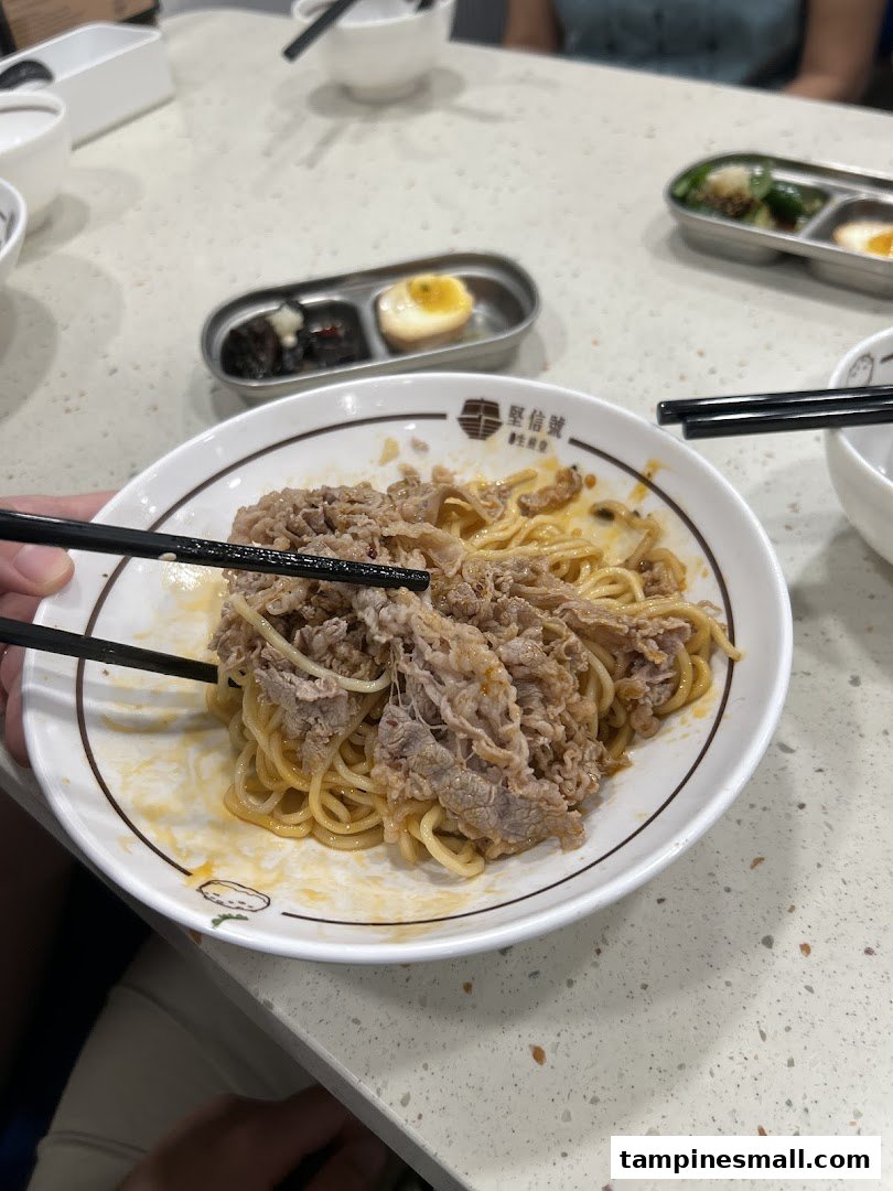 A close-up of delicious beef noodles being enjoyed at Ging Sun Ho King of Bun.