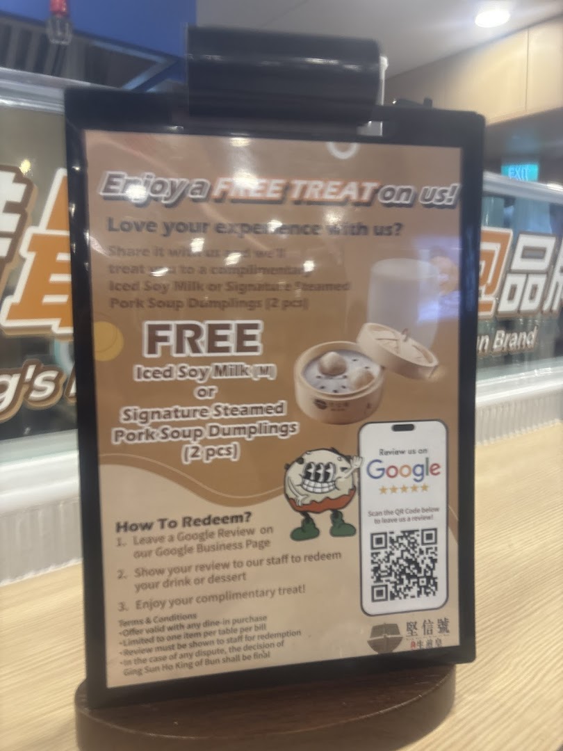 A promotional sign from Ging Sun Ho King of Bun offering a free treat for leaving a Google review.