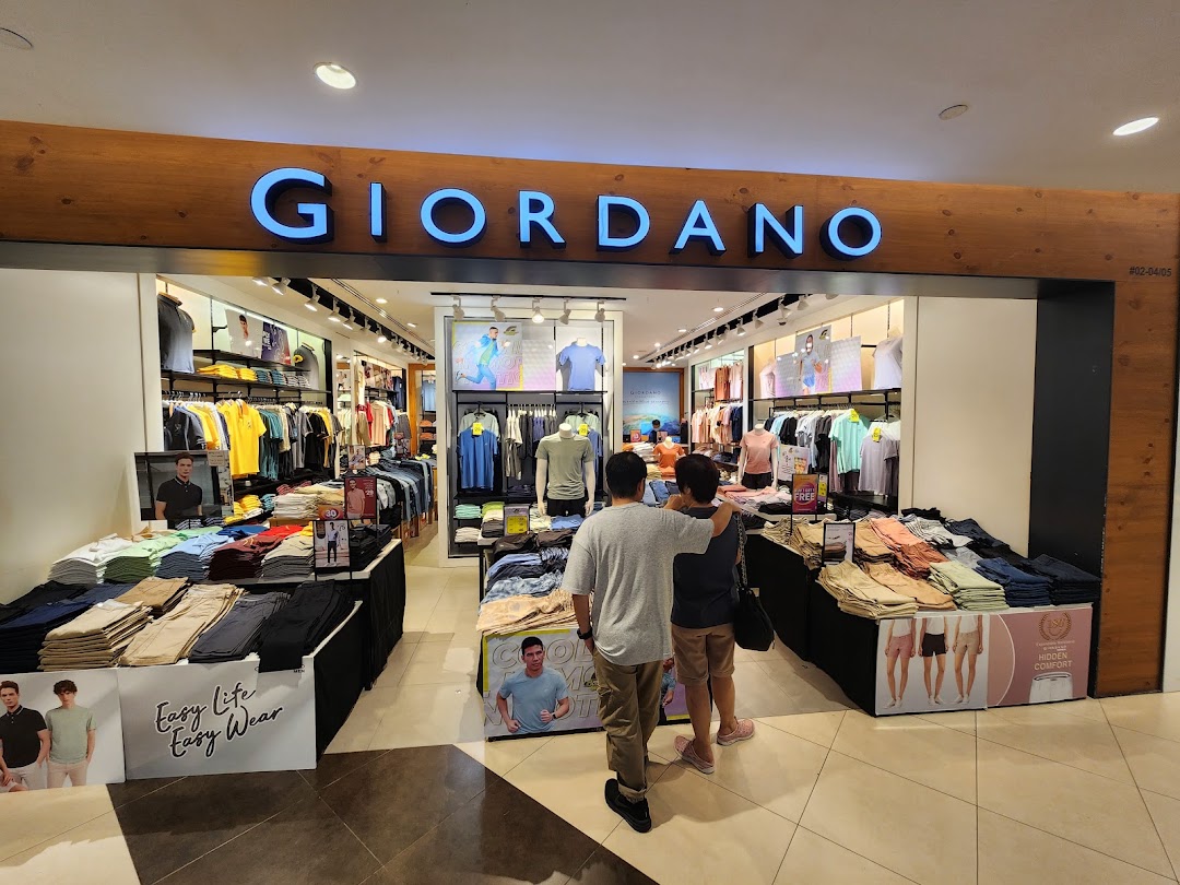 The inviting entrance of a Giordano clothing store, showcasing a wide range of casual wear and apparel.