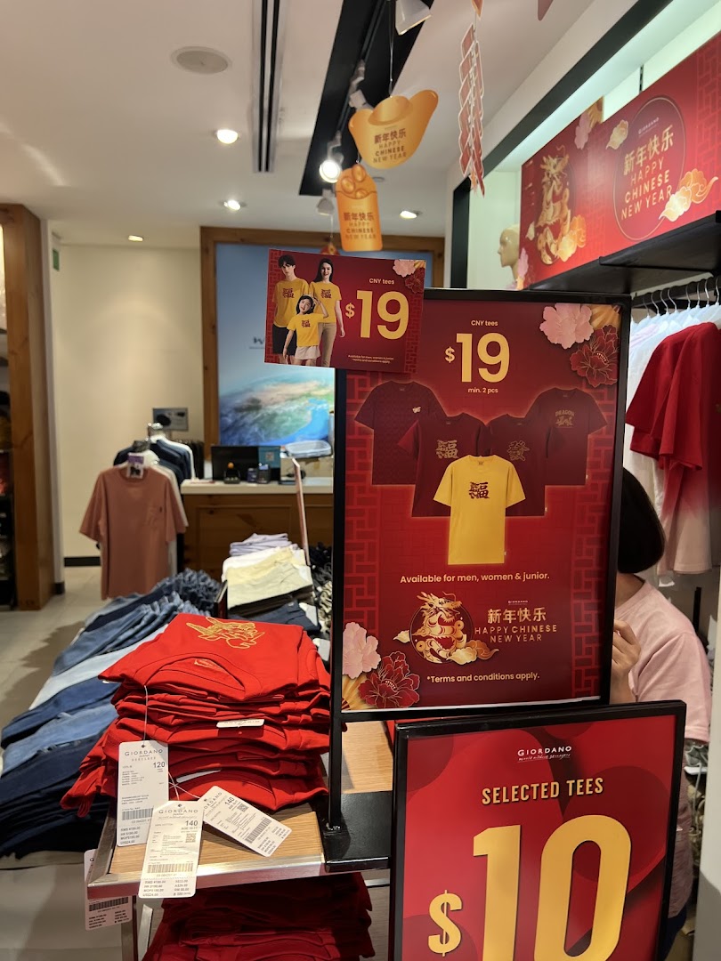 Giordano store interior showcasing Chinese New Year apparel and promotional offers on festive and selected tees.