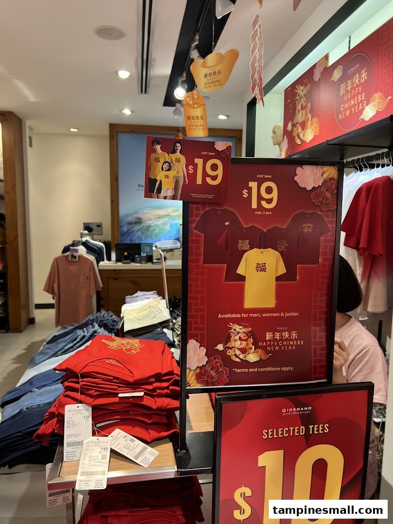 Giordano store interior showcasing Chinese New Year apparel and promotional offers on festive and selected tees.