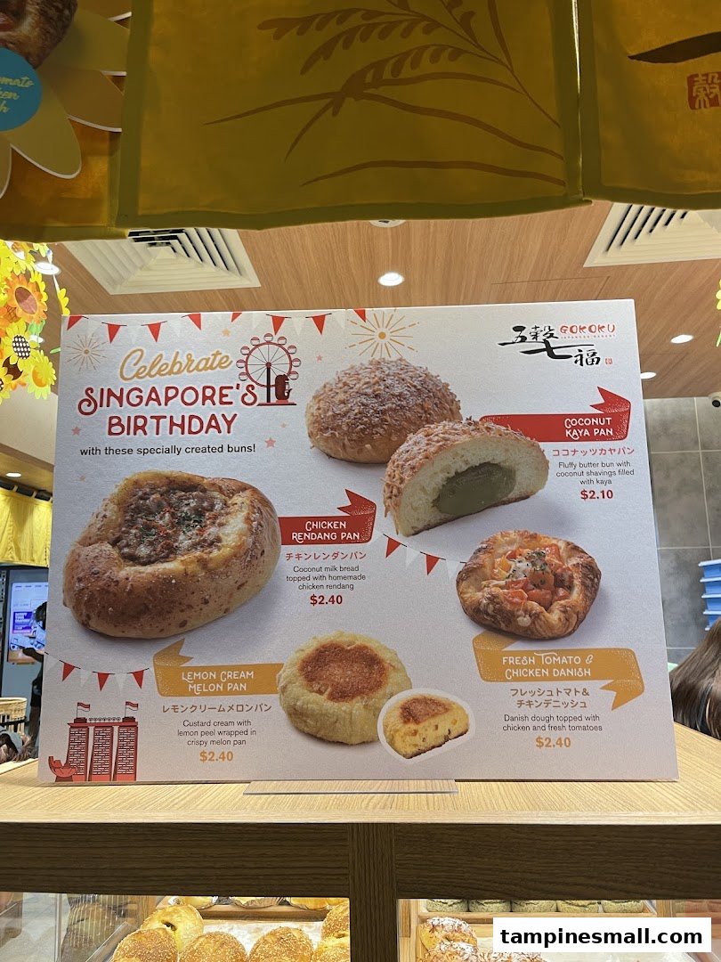 A promotional display board showcasing special buns for Singapore's Birthday at Gokoku Japanese Bakery.